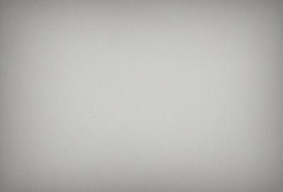 The image is a white wall with a few blue dots scattered across it. The primary subject is the wall, and the setting is a room with a white background. The visual style is a combination of a photo and a drawing, creating a unique and artistic appearance. The colors and mood are predominantly white and blue, giving the scene a calm and serene atmosphere.