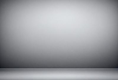 The primary subject of the image is a large, empty white wall. The setting is a room with a gray background, which creates a clean and minimalist atmosphere. The visual style is a photo, capturing the stark contrast between the white wall and the gray background. The colors and mood of the image are predominantly white and gray, giving it a calm and serene appearance.