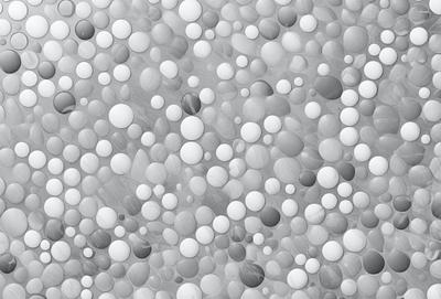 The primary subject of the image is a pattern of white and grey balls, which are arranged in a visually appealing manner. The setting is a grey background, which provides a contrasting and neutral backdrop for the balls. The visual style of the image is a combination of digital art and illustration, as the balls are arranged in a way that resembles a painting or drawing. The colors and mood of the image are predominantly neutral, with the white and grey balls creating a sense of calmness and simplicity.