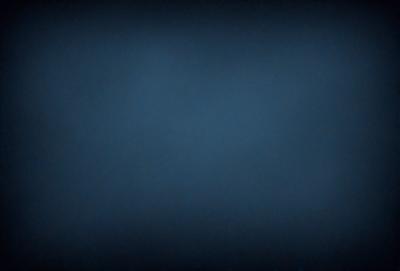 The primary subject of the image is a blue sky with no clouds. The setting is a dark blue background, which creates a contrasting effect with the sky. The visual style is a simple, monochromatic image with no additional elements or textures. The colors and mood of the image are predominantly dark and moody, with the blue sky serving as the main focal point.