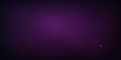 The image features a purple background with a single star visible in the sky. The star is located towards the center of the image, and it appears to be the main focus of the scene. The purple background creates a calm and serene atmosphere, while the star adds a touch of celestial beauty to the composition.
