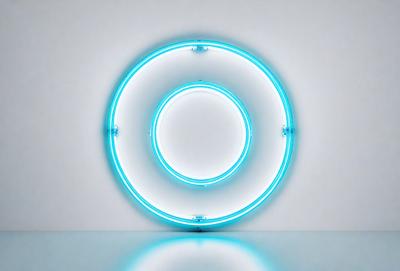 The primary subject of the image is a large, illuminated blue circle. The circle is positioned on a white wall, which serves as the setting and background. The visual style of the image is a combination of a photo and digital art, creating a unique and eye-catching appearance. The dominant colors in the image are blue and white, giving the scene a clean and modern feel.