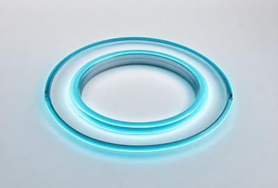 The primary subject of the image is a blue ring, which is the main object, scene, or focus of the image. The ring is placed on a white surface, which serves as the setting or background. The visual style of the image is a photo, as it captures a real-life object in its natural environment. The colors and mood of the image are predominantly blue, creating a calm and serene atmosphere.