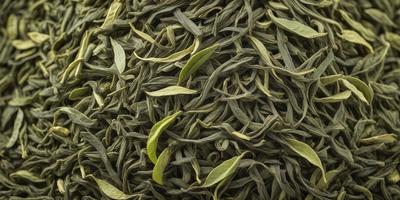 The primary subject of the image is a large pile of green leaves, possibly tea leaves, arranged in a stack. The leaves are green and appear to be fresh and vibrant. The setting is a close-up of the leaves, showcasing their texture and details. The visual style is a realistic representation of the leaves, and the colors are predominantly green, creating a natural and fresh atmosphere.