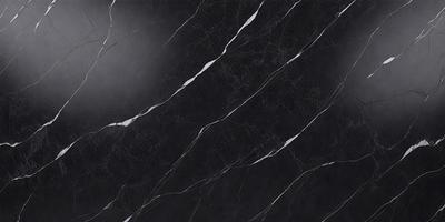 The primary subject of the image is a black marble countertop. The setting is a kitchen, with the countertop being the main focus of the scene. The visual style is a photo, capturing the details of the marble countertop. The colors and mood of the image are predominantly dark, with the black marble countertop being the most prominent feature.