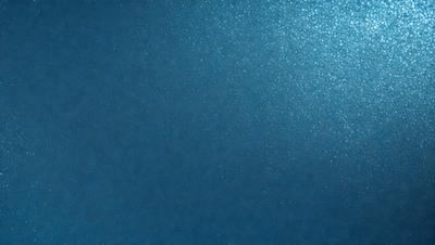 The primary subject of the image is a blue background with a shiny, reflective surface. The setting appears to be a dark room, possibly a nightclub or a darkened room for a special event. The visual style of the image is a combination of a photo and a digital art, creating a unique and captivating atmosphere. The dominant colors in the image are blue and shiny, giving the scene a cool and sophisticated mood.
