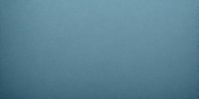 The primary subject of the image is a large, empty, and dark blue sky. The setting is a vast, open space with no visible landmarks or objects. The visual style is a natural, untouched, and unaltered representation of the sky. The colors and mood convey a sense of tranquility and vastness.
