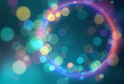 The primary subject of the image is a brightly colored, swirling, and circular pattern. The setting is a dark background, which contrasts with the vibrant colors of the pattern. The visual style appears to be a combination of a photo and digital art, creating a unique and eye-catching effect. The dominant colors are blue, green, and purple, giving the image a lively and energetic atmosphere.