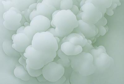 The primary subject of the image is a cloudy, white, and green background. The setting is a sky, and the visual style is a photo. The dominant colors are white and green, creating a calm and serene atmosphere.