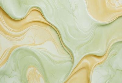 The primary subject of the image is a green and yellow swirling pattern, which appears to be a painting or a digital artwork. The setting is a wall, and the visual style is a combination of photo and digital art. The dominant colors are green and yellow, creating a vibrant and lively atmosphere.