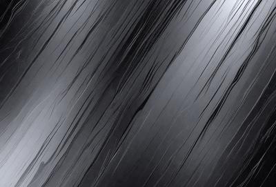 The primary subject of the image is a black and white photo of a wavy, curly, and textured pattern. The setting is a dark background, which contrasts with the pattern. The visual style is a close-up of the pattern, showcasing its intricate details. The colors and mood of the image are predominantly dark and moody, with the black and white color scheme adding to the dramatic atmosphere.