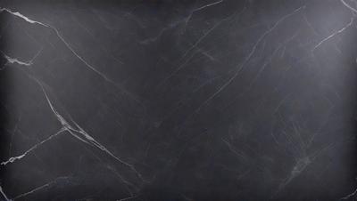 The primary subject of the image is a black marble countertop. The setting is a kitchen, with the countertop being the main focus of the scene. The visual style is a close-up of the marble countertop, showcasing its texture and pattern. The colors and mood of the image are predominantly dark, with the black marble countertop being the main source of contrast.
