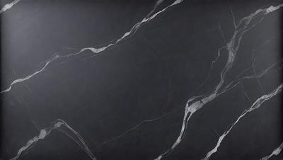 The primary subject of the image is a black marble countertop. The setting is a kitchen, with the countertop being the main focus of the scene. The visual style is a photo, capturing the details of the marble countertop. The colors and mood of the image are dark and moody, with the black marble countertop being the dominant feature.