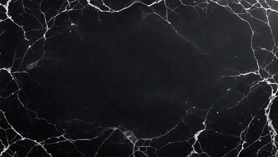 The primary subject of the image is a black marble countertop. The setting is a dark room, and the visual style is a close-up of the marble countertop. The colors and mood of the image are predominantly dark, with the black marble countertop being the main focus.