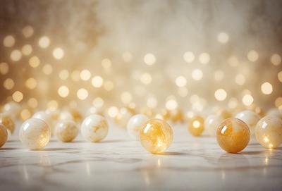 The primary subject of the image is a group of lighted balls, which are scattered across a white surface. The setting appears to be a studio or a controlled environment, as the balls are placed in a specific pattern. The visual style of the image is a combination of photo and digital art, creating a unique and eye-catching display. The colors and mood of the image are predominantly white and warm, giving the scene a clean and inviting atmosphere.