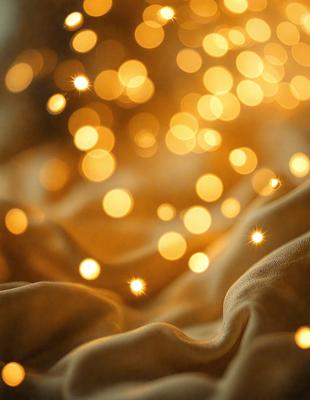 The primary subject of the image is a yellow cloth with a pattern of yellow lights on it. The setting is a room with a yellow cloth covering the floor. The visual style is a close-up of the yellow cloth with the yellow lights. The colors and mood of the image are warm and inviting, with the yellow lights creating a cozy atmosphere.