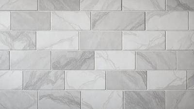 The primary subject of the image is a large, white marble wall with a pattern of small, square tiles. The setting is a room with a white brick wall, which adds to the overall visual style. The image is a photo, capturing the intricate details of the marble wall and the brick wall. The colors and mood of the image are predominantly white, giving it a clean and elegant appearance.