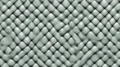 The primary subject of the image is a patterned fabric, which appears to be a knitted or woven material. The setting is a gray background, which provides a neutral and clean appearance. The visual style is a close-up of the fabric, showcasing its intricate design and texture. The colors and mood of the image are predominantly gray, giving it a calm and sophisticated atmosphere.