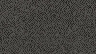 The primary subject of the image is a patterned wallpaper with a zigzag design. The setting is a room with a grey color scheme. The visual style is a close-up of the wallpaper, showcasing its intricate pattern. The colors and mood of the image are predominantly grey, giving it a calm and sophisticated atmosphere.