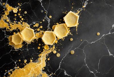 The primary subject of the image is a close-up of a honeycomb, with the honey dripping out of it. The setting is a black background, which contrasts with the honeycomb and adds a dramatic effect to the scene. The visual style is a close-up, which emphasizes the details of the honeycomb. The colors are predominantly yellow, which is the color of the honey, and the overall atmosphere is one of natural beauty and richness.