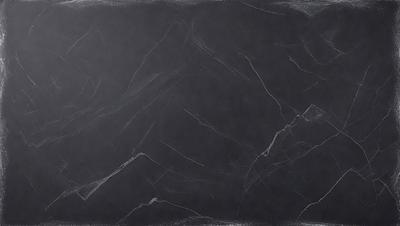 The primary subject of the image is a black marble countertop. The setting is a kitchen, with the countertop being the main focus of the scene. The visual style is a close-up of the marble countertop, showcasing its texture and details. The colors and mood of the image are predominantly dark, with the black marble countertop being the main source of contrast and visual interest.