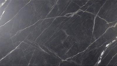 The primary subject of the image is a black marble countertop. The setting is a kitchen, with the countertop being the main focus of the scene. The visual style is a close-up of the marble countertop, showcasing its texture and pattern. The colors and mood of the image are predominantly dark, with the black marble countertop being the main source of contrast.