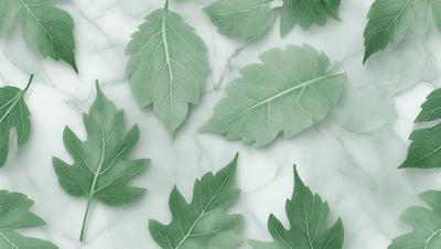 The image features a collection of green leaves arranged on a white marble surface. The leaves are spread out, covering a significant portion of the marble, creating a visually appealing and natural scene. The primary subject of the image is the green leaves, which are the main focus and the setting is a white marble surface. The visual style of the image is a close-up of the leaves, and the colors and mood are predominantly green, giving the scene a fresh and lively atmosphere.