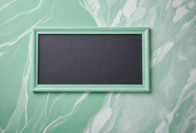 The primary subject of the image is a green frame with a black screen. The setting is a wall with a green background, and the visual style appears to be a photo. The colors and mood of the image are predominantly green, creating a calm and serene atmosphere.