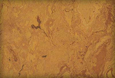 The primary subject of the image is a close-up of a marble-like surface with a yellowish hue. The setting is a wall, and the visual style appears to be a photo. The colors and mood of the image are warm and inviting, with the yellowish hue creating a sense of warmth and comfort.