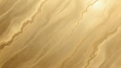 The primary subject of the image is a close-up of a marble surface, showcasing its intricate and textured design. The setting is a room with a yellowish-gold color scheme, which adds warmth and sophistication to the space. The visual style is a realistic representation of the marble, capturing its natural beauty and details. The colors and mood of the image are predominantly warm and inviting, with the gold and brown tones creating a sense of luxury and elegance