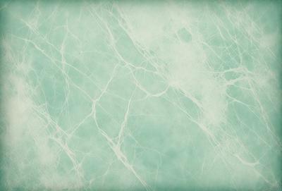 The primary subject of the image is a close-up of a white marble wall. The setting is a room with a green tint, possibly a bathroom. The visual style is a photo, and the dominant colors are white and green. The overall atmosphere is clean and elegant.