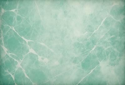 The primary subject of the image is a white and green marble wall. The setting is a bathroom, as indicated by the presence of a marble wall. The visual style is a photo, showcasing the marble wall's texture and pattern. The dominant colors are white and green, creating a clean and refreshing atmosphere.