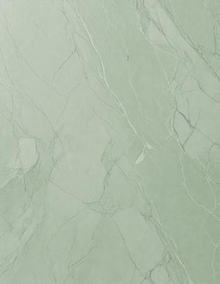 The primary subject of the image is a marble wall with a green tint. The setting is a room with a white background. The visual style is a photo of a marble wall. The colors and mood are predominantly green, giving the wall a natural and serene appearance.