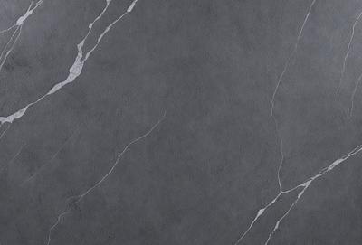 The primary subject of the image is a grey marble wall with a pattern of white veins. The setting is a room with a grey marble floor. The visual style is a close-up of the marble wall, showcasing its texture and pattern. The colors and mood of the image are predominantly grey, with the white veins adding a touch of contrast.
