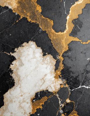 The primary subject of the image is a marble surface with a gold-colored pattern. The setting is a black background, which contrasts with the gold and white marble. The visual style is a close-up of the marble surface, showcasing the intricate pattern and texture. The colors and mood of the image are elegant and sophisticated, with the gold and white marble creating a luxurious and timeless atmosphere.