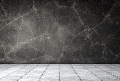 The primary subject of the image is a wall with a marble texture. The setting is a room with a white floor, and the visual style is a photo. The colors and mood of the image are predominantly white, giving it a clean and minimalist appearance.