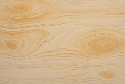 The primary subject of the image is a wooden surface with a unique and intricate pattern. The setting is a room with a wooden floor, and the visual style appears to be a combination of a photo and a digital art or illustration. The dominant colors in the image are shades of brown and yellow, creating a warm and natural atmosphere.