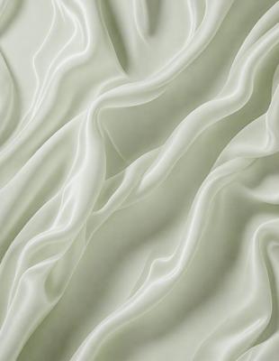 The primary subject of the image is a white, textured wall. The setting is a room with a white wall, and the visual style is a close-up of the wall. The colors and mood of the image are predominantly white, giving it a clean and minimalist appearance.