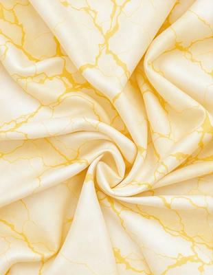 The primary subject of the image is a yellow and white fabric, which is the main object, scene, or focus of the image. The setting is a close-up of the fabric, showcasing its texture and pattern. The visual style is a photo, capturing the details of the fabric. The colors and mood of the image are predominantly yellow and white, creating a warm and inviting atmosphere.