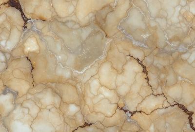 The primary subject of the image is a marble surface with a pattern of holes and cracks. The setting is a close-up of the marble, showcasing its unique texture and appearance. The visual style is a realistic representation of the marble, capturing its natural beauty. The colors and mood of the image are predominantly neutral, with the marble's natural hues and the contrasting holes and cracks creating a sense of depth and complexity.