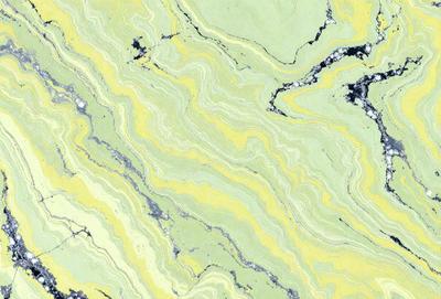 The image features a yellow and green marbled pattern on a stone surface. The primary subject is the intricate design of the marbled pattern, which creates a visually appealing and unique texture. The setting is a stone wall or countertop, which serves as the background for the pattern. The visual style is a close-up of the marbled pattern, emphasizing its details and beauty. The colors and mood of the image are predominantly yellow and green, giving it a warm and natural atmosphere.