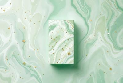 The primary subject of the image is a square box with a green background. The box is placed on a green surface, which appears to be a marbled or textured material. The visual style of the image is a combination of photo and digital art, creating a unique and eye-catching design. The colors and mood of the image are predominantly green, giving it a fresh and natural feel.