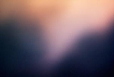 The primary subject of the image is a cloudy sky. The setting is a dark, cloudy background, which creates a moody atmosphere. The visual style is a photo, capturing the beauty of the cloudy sky. The colors are predominantly dark and gray, with some hints of blue and purple, adding to the dramatic and mysterious mood of the scene.