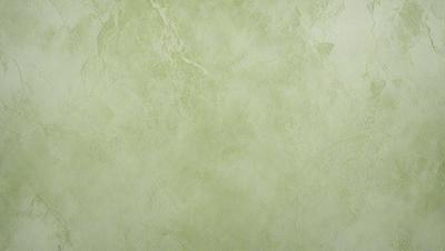 The image features a large, green wall with a textured surface. The wall appears to be made of marble or a similar material, giving it a unique and elegant appearance. The green color of the wall creates a calming and soothing atmosphere, making it an ideal choice for a living space or a public area.