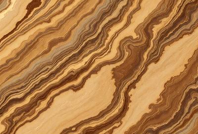The primary subject of the image is a wooden table with a unique and intricate pattern on its surface. The table appears to be made of wood and has a natural texture. The setting is indoors, with the table being the main focus of the scene. The visual style of the image is a close-up of the wooden table, showcasing its distinctive pattern. The colors and mood of the image are warm and inviting, with the wooden table serving as a beautiful and functional piece of furniture.