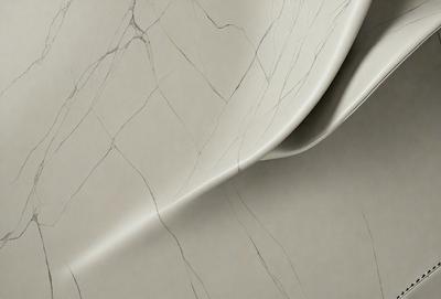 The primary subject of the image is a marble countertop with a cracked and textured surface. The setting is a kitchen, and the visual style is a close-up of the marble countertop. The colors and mood of the image are predominantly gray and neutral, with the cracked marble adding a sense of depth and character to the surface.