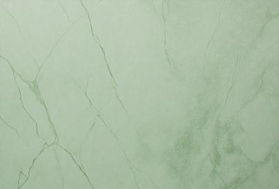 The primary subject of the image is a green marble wall with a pattern of cracks and crevices. The setting is a room with a green background, and the visual style is a close-up of the marble wall. The colors and mood of the image are predominantly green, giving it a natural and serene atmosphere.
