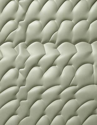 The image features a large, textured wall with a patterned design. The wall appears to be made of a combination of concrete and fabric, giving it a unique and interesting appearance. The primary subject of the image is the wall, which serves as the main focus of the scene. The setting is indoors, likely in a room or an interior space. The visual style of the image is a blend of digital art and textured wall design, creating a modern and artistic atmosphere. The colors and mood of the image are pre
