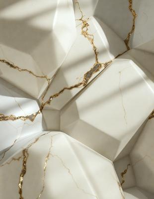 The primary subject of the image is a white marble wall with gold accents. The setting is a room with a white marble wall, and the visual style is a photo. The dominant colors are white and gold, creating a luxurious and elegant atmosphere.