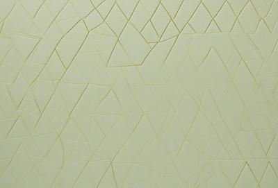 The primary subject of the image is a white wall with a pattern of triangles. The setting is a room with a white background. The visual style is a patterned wall, which gives the room a unique and interesting appearance. The dominant colors are white and grey, creating a clean and minimalist atmosphere.